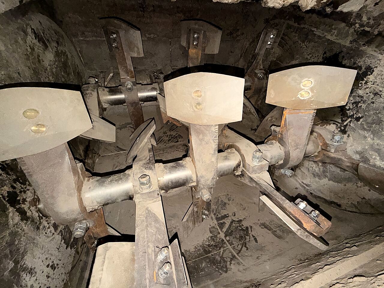 Plant mixer paddles and shafts chipped back to clean steel after hardened buildup removal